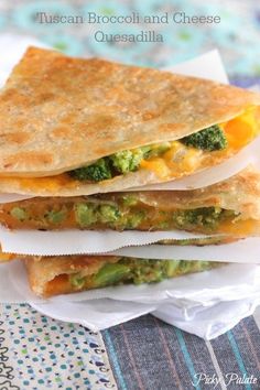 three quesadillas stacked on top of each other with broccoli and cheese