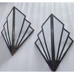 two art deco mirrors on a white wall