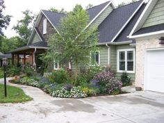 a house that has some flowers in front of it