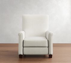 a white chair sitting on top of a hard wood floor