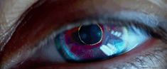 the iris of a person's eye with blue and red colors on it,