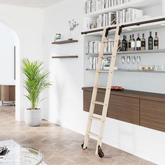 a ladder leaning up against a wall next to a table with bottles and glasses on it