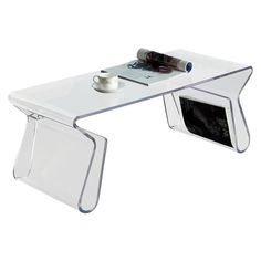 a white desk with a magazine rack and coffee cup on it's side, against a white background