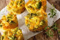 broccoli and cheese muffins sitting on wax paper