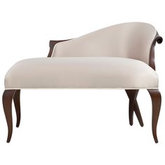 an upholstered chaise lounge chair with curved backrests and wooden legs