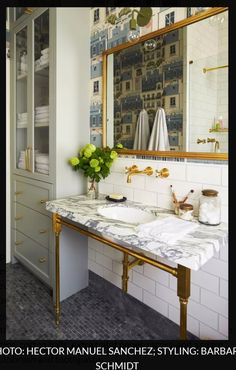 a bathroom with two sinks and a large mirror over it's counter top,