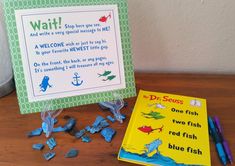 a dr seuss book and some blue fish on a table