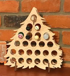 a wooden christmas tree with wine bottles in it