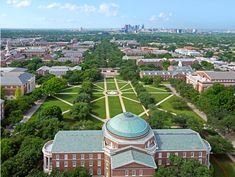 an aerial view of a campus with trees and buildings in the background