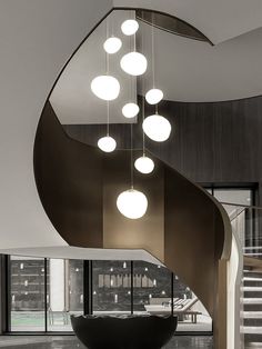 a spiral staircase with lights hanging from it