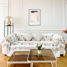 a living room filled with furniture and a painting on the wall above it's coffee table