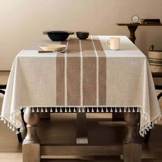 a table with a white and brown striped tablecloth