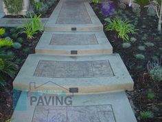 the steps lead up to an outdoor area with plants and flowers on either side of them