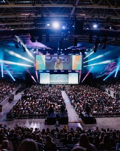 a large auditorium filled with people and lights