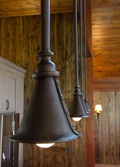 three lights hanging from the ceiling in a kitchen