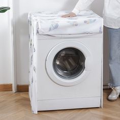 a person standing next to a washing machine