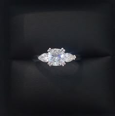 an oval diamond ring with three pear shaped diamonds