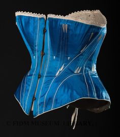 Late 1860s. "Corsets were shaped to place somewhat less pressure on the hips. The resulting silhouette, though hidden under layers of fabric, was a shapely hourglass. As seen in in our blue silk satin corset, godets at hip and bust allowed for a relatively roomy fit." Victorian Ball Gowns, Blue Corset