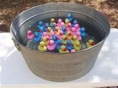 a bucket filled with rubber ducks on top of a table