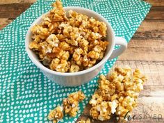 a white bowl filled with caramel popcorn on top of a green and white napkin