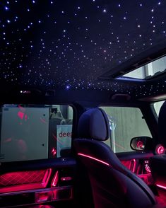 the interior of a car with stars on the ceiling