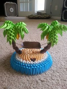 a blue and white frisbee with two palm trees on it sitting on the floor