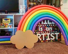 a cardboard rainbow with a sign that says it's an artist