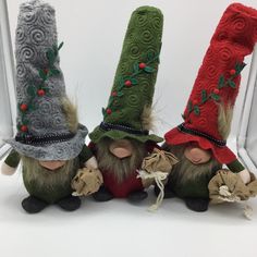 three small gnomes with hats on their heads