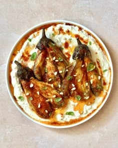 a white bowl filled with food on top of a table