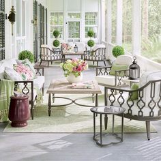 a porch with chairs and tables on it