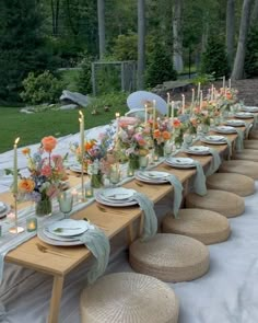 a long table is set up with plates and place settings for an outdoor dinner party