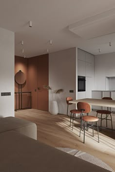 a living room filled with furniture next to a kitchen and dining room table in front of a window