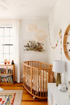 a baby crib in a room with white walls and wood floors, along with an instagram