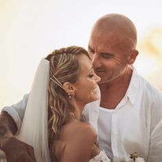 a bride and groom smile at each other