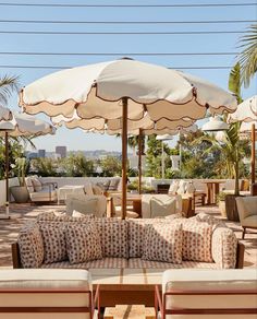 an outdoor seating area with umbrellas and chairs