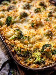 a casserole dish with broccoli and cheese in it on a table