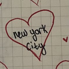 the words new york city written in black ink on a white tiled wall with red hearts