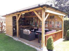 a wooden shed with outdoor furniture in it