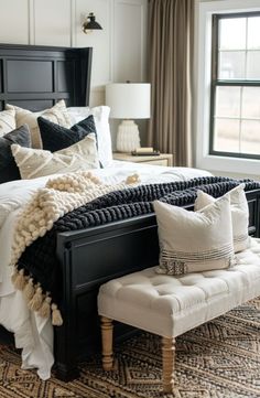 a black and white bed in a bedroom