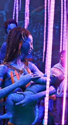 two women dressed in blue and orange are dancing