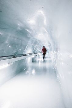 a man is walking through an ice cave