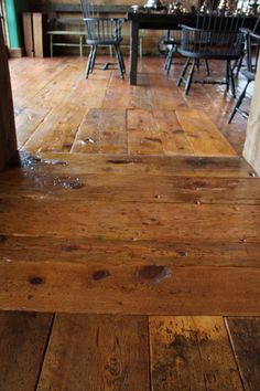 a wooden floor that has been cleaned and is in the process of being stained with paint