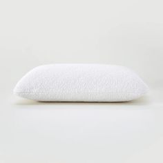 a white pillow sitting on top of a table