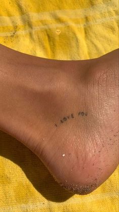 a person's foot with the word love me written on it in black ink