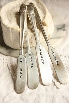 three silver spoons sitting on top of a white doily next to each other