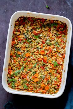 a casserole dish filled with carrots and other vegetables