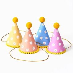 Four Paper Source Retro Daisy Party Hats, featuring vibrant colors and yellow pom-poms, arranged in a row, add a festive touch to any celebration. Tissue Garland, Daisy Party, Camping Theme Party, Retro Daisy, Halloween Party Themes, Pink Halloween, Theme Party Decorations, Paper Source, Milestone Birthdays