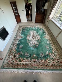 a person standing on the floor in front of a rug