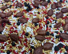 chocolate coins and sprinkles are scattered on top of red, white, and blue cereal