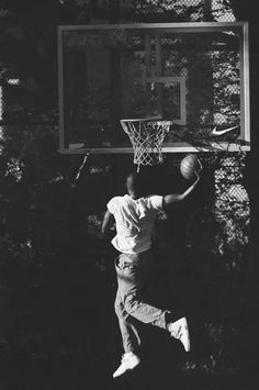 black and white photograph of a man playing basketball